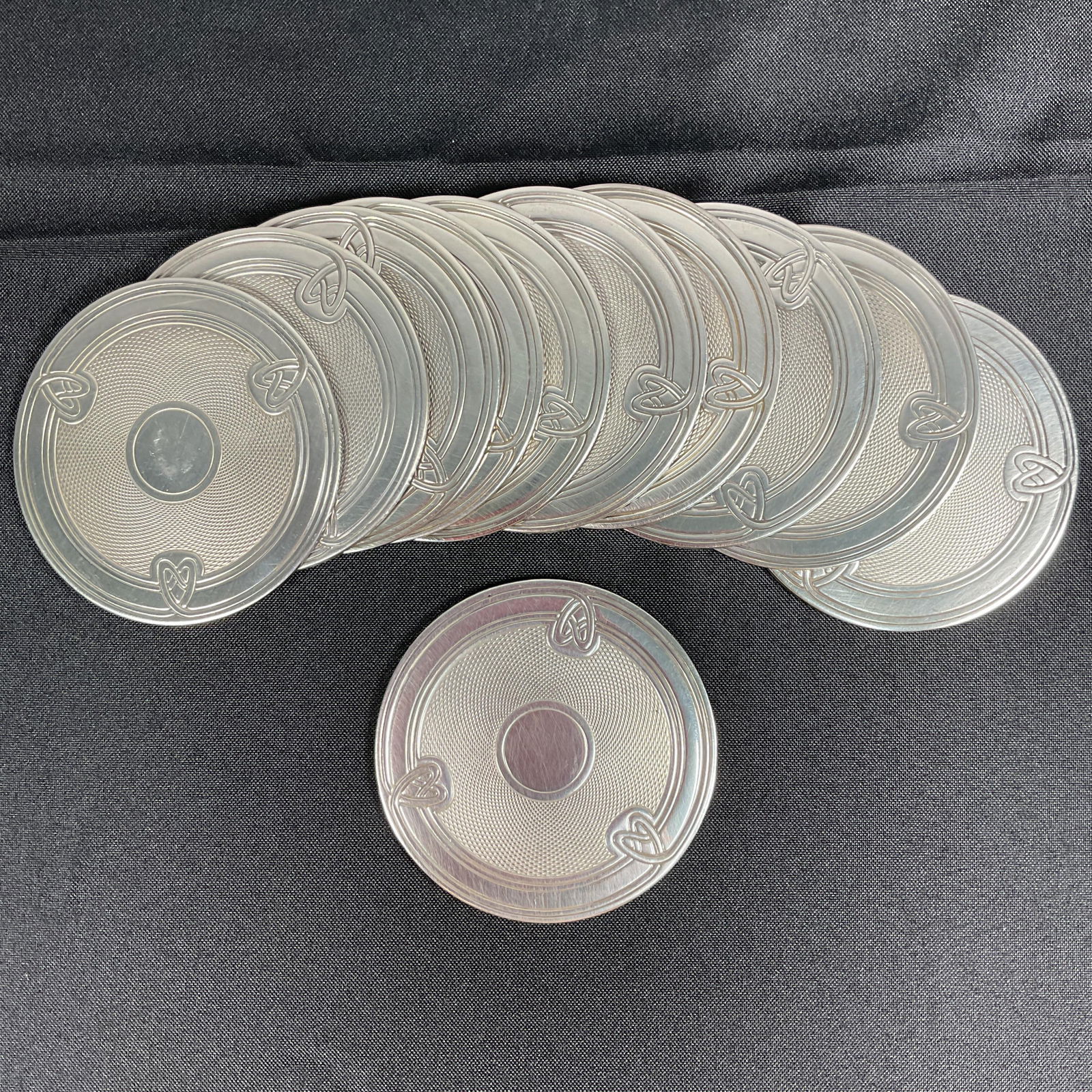 Christofle Metal coasters, set of 10: Description: A stunning set of 10 Christofle metal coasters, showcasing the brand’s renowned craftsmanship and timeless elegance. These coasters are ideal for protecting surfaces while adding a soph