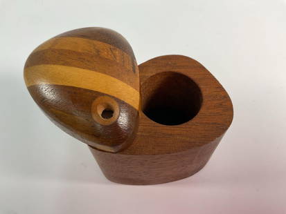 "Handcrafted Wooden Puzzle Box with Striped Lid" Richard Rothbard: This unique handcrafted wooden puzzle box features a rounded, striped lid that fits seamlessly into its rectangular base. The lid showcases a beautiful contrast of light and dark wood grains, creating