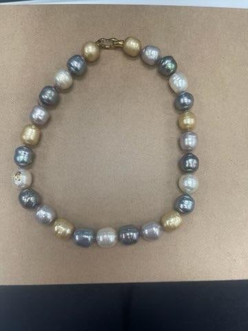 Multi-Colored Pearl Necklace: Stunning multi-colored pearl necklace featuring large, lustrous pearls in shades of gold, silver, gray, and cream. The pearls are evenly spaced and strung together in a single strand, showcasing a har