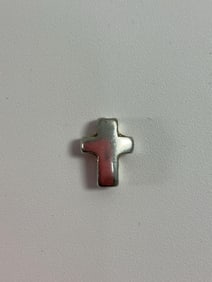 Small cross-shaped charm or pendant