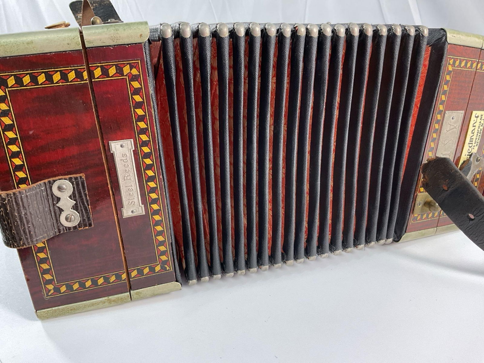 Nicolo Salanti Armonica Italiano - Button Accordion: This is a vintage Nicolo Salanti "Armonica Italiano" button accordion, a well-crafted instrument featuring a wooden case with intricate inlays and decorative metal accents. The bellows, adorned with a