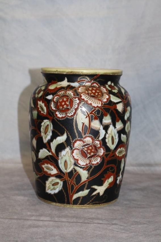 Hand-Painted Nippon Porcelain Vase: A beautifully hand-painted Nippon porcelain vase featuring an intricate floral design with gold accents on a black background. The vase is marked "Hand Painted Nippon" on the base, indicating it was p