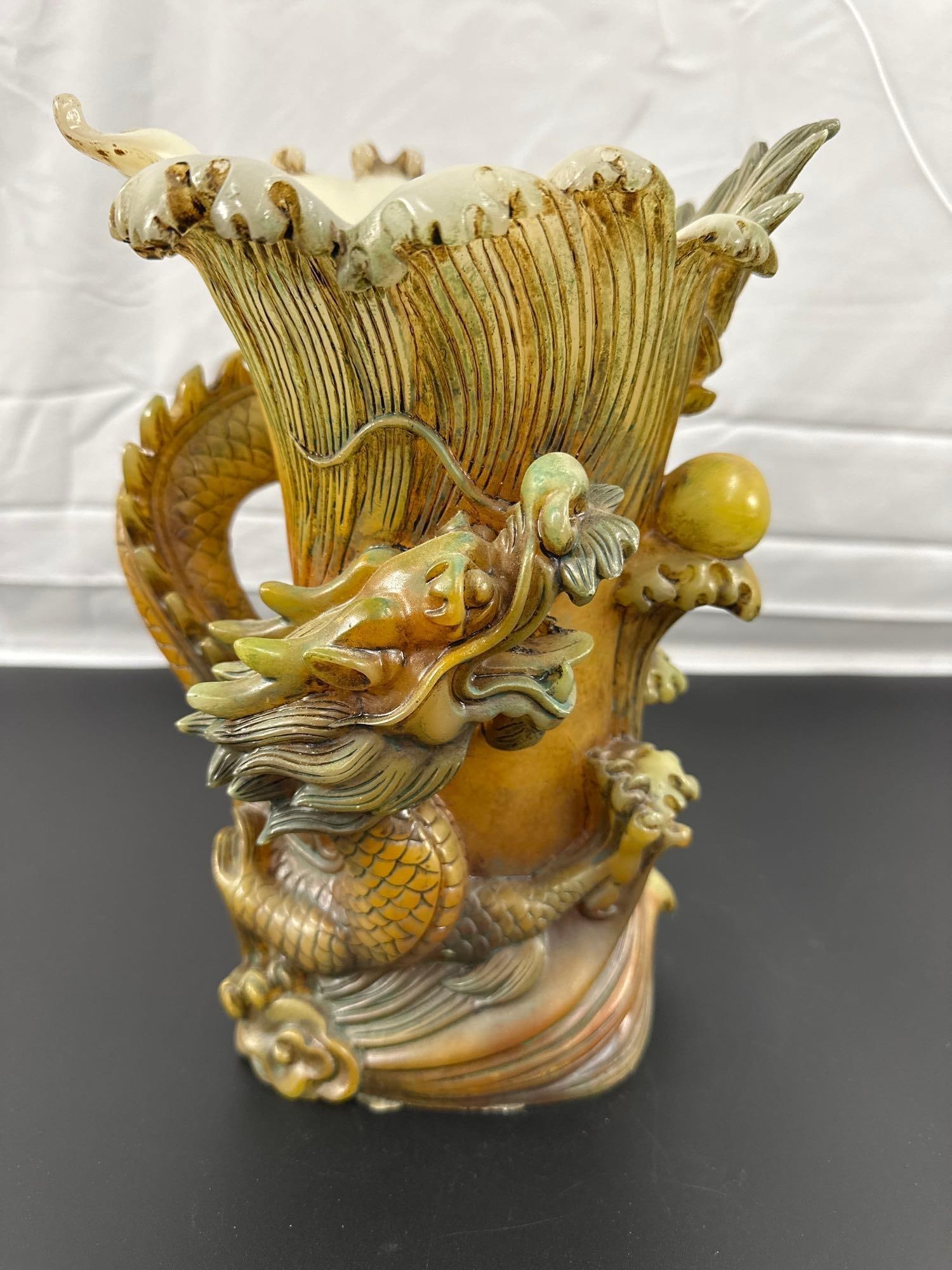 Chinese Dragon Carved Soapstone Vase: This is a striking carved soapstone vase with a highly detailed and dynamic design featuring a Chinese dragon entwined around the vase. The dragon's scales, claws, and flowing mane are meticulously cr