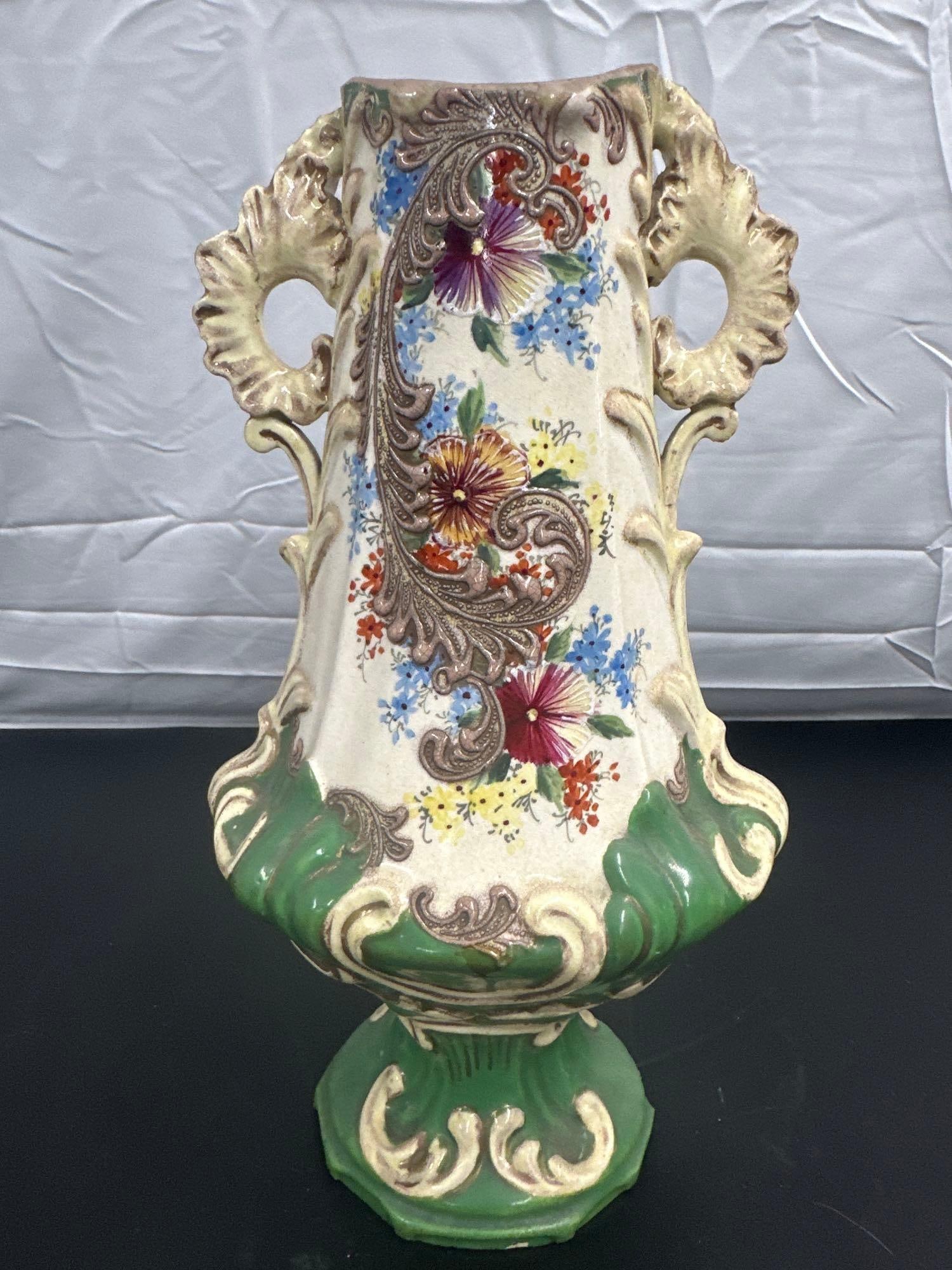 Vintage Capodimonte Ceramic Vase with Floral Relief and Scrollwork: This vibrant vintage ceramic vase features an ornate design with bold floral reliefs and intricate scrollwork. The vase showcases a striking combination of rich green and cream tones, highlighted by h