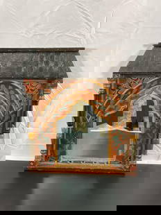 Antique Moroccan Wall Mirror: This unique vintage mirror features a hand-painted wooden frame with vibrant floral and vine motifs in traditional Moroccan design. The frame includes an arched, temple-like opening surrounding the mi