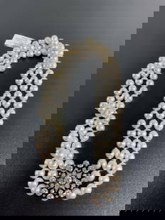 Victorian Gold & Silver Pearl Necklace: Victorian Gold & Silver Topped 3 strand Pearl Necklace weighing 144.4 grams. Pearls measure between 8.5 mm - 9.5 mm. Clasp is set with 9 old mine Diamonds weighing app 1.20 Ct. F-H Color. VVS - VS Cla