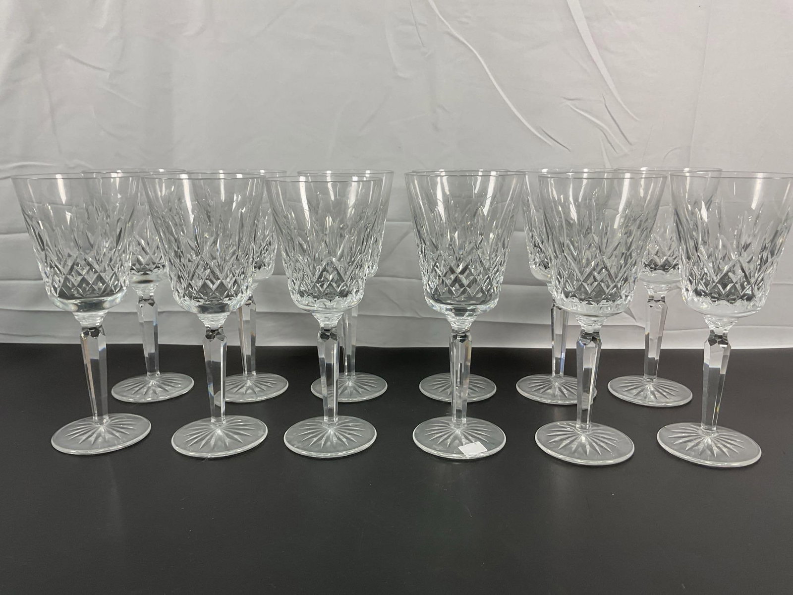 Set of Waterford Crystal Wine Glasses â€“ Lismore Pattern: This set of Waterford crystal wine glasses features the classic Lismore cut pattern, one of Waterford's most beloved and recognizable designs. The diamond and wedge cuts reflect light beautifully, enh