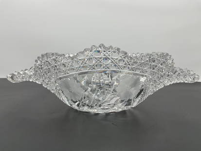 Vintage American Brilliant Cut Glass Serving Bowl with Handles: A stunning vintage cut glass serving bowl featuring an elaborate geometric pattern with starburst and crosshatch motifs. The bowl has an elegant scalloped rim with raised detailing and two curved hand