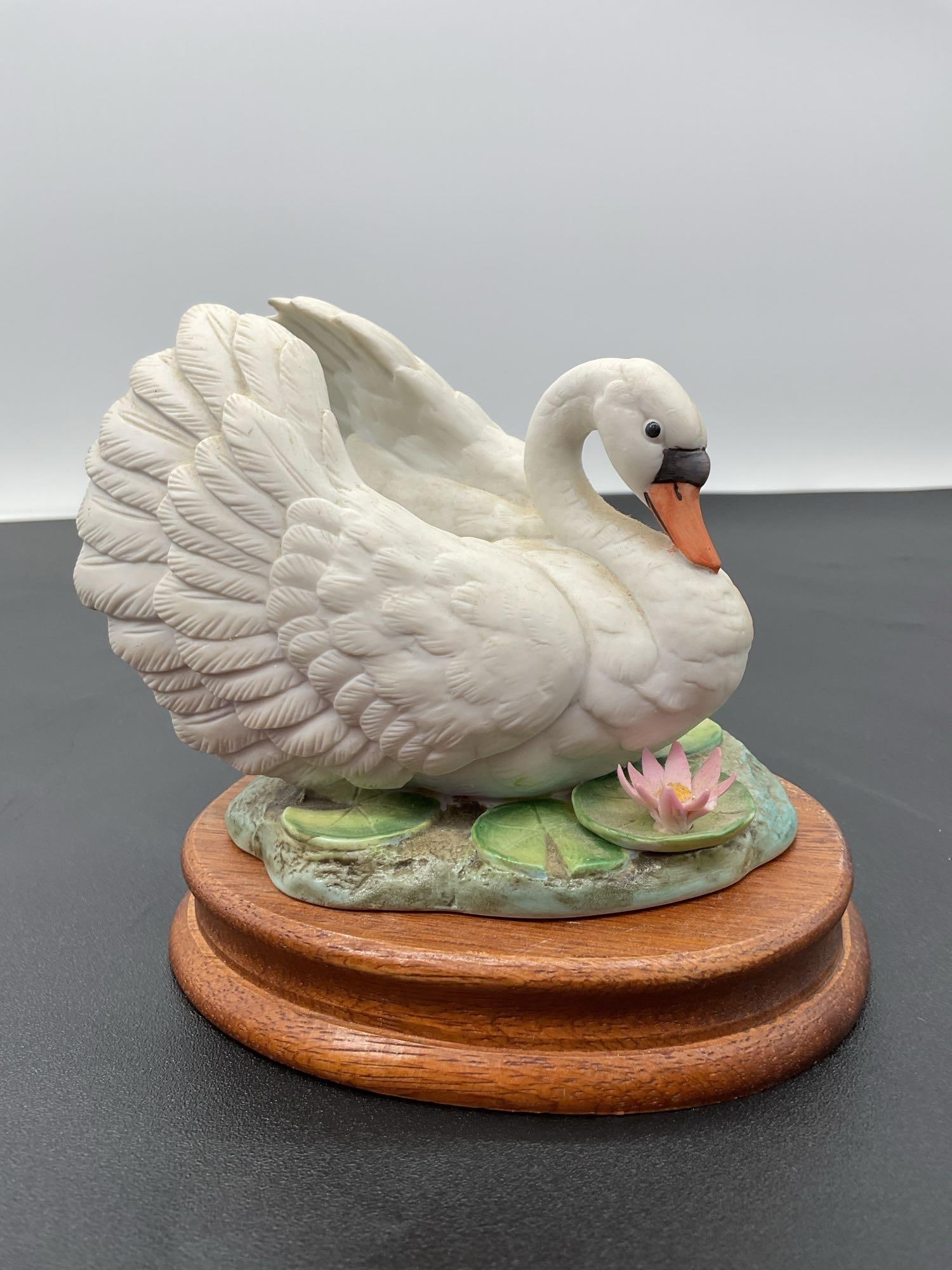 Mute Swan Figurine by Andrea: A delicately crafted porcelain figurine titled “Mute Swan” by Andrea, part of the Andrea by Sadek collection. Made in Japan, this piece depicts a graceful white swan with finely detailed feath
