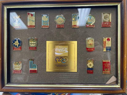 Coca-Cola Olympic Commemorative Pin Collections: These framed Coca-Cola Olympic pin collections feature limited-edition sets celebrating various Olympic Games. The first three frames contain collectible pins representing past Winter and Summer