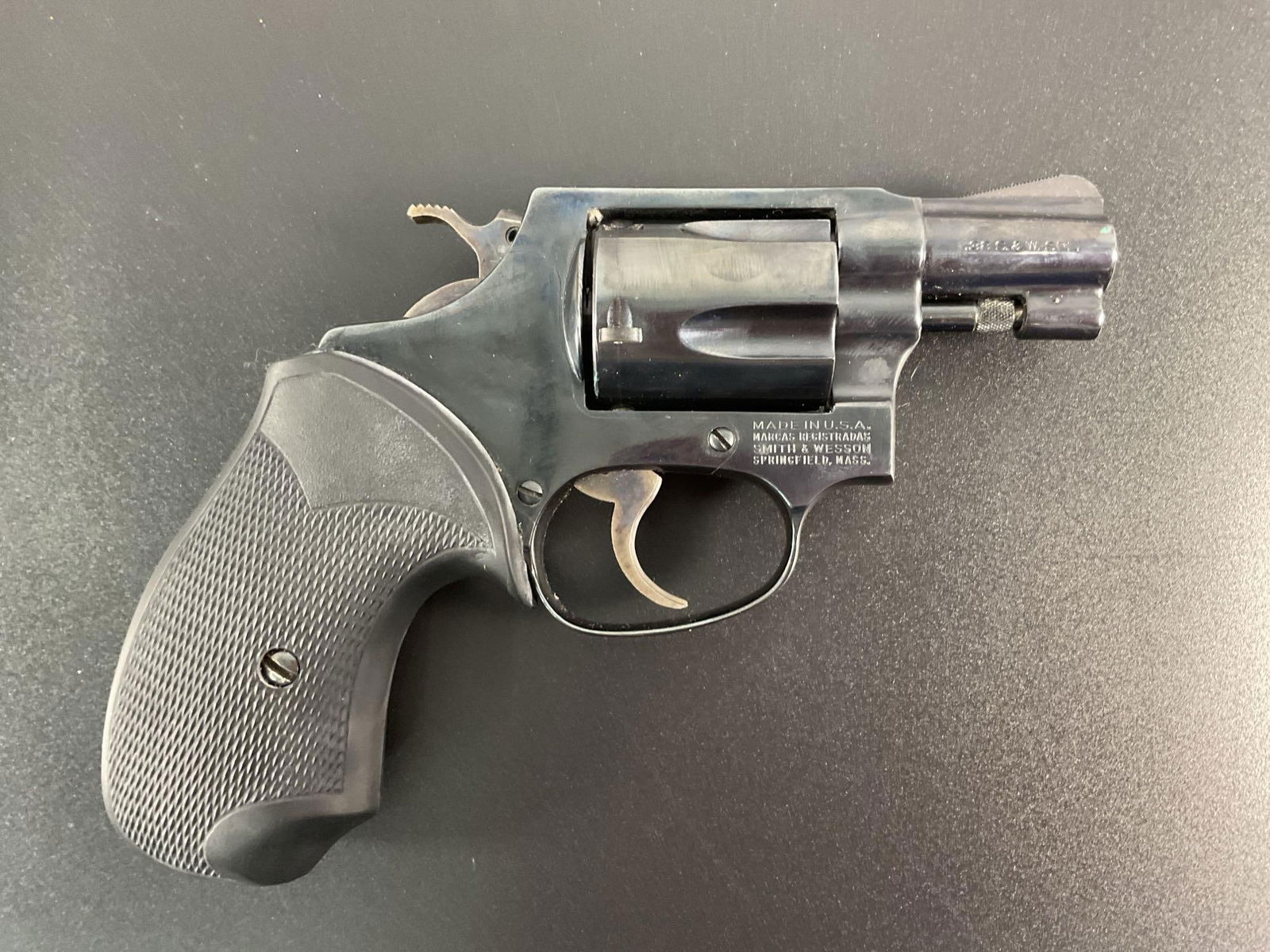 Smith & Wesson Model 36 "Chief’s Special": The firearm shown is a Smith & Wesson Model 36 "Chief’s Special", a small-frame .38 Special revolver with a blued steel finish. This model is a J-Frame revolver, which was originally des