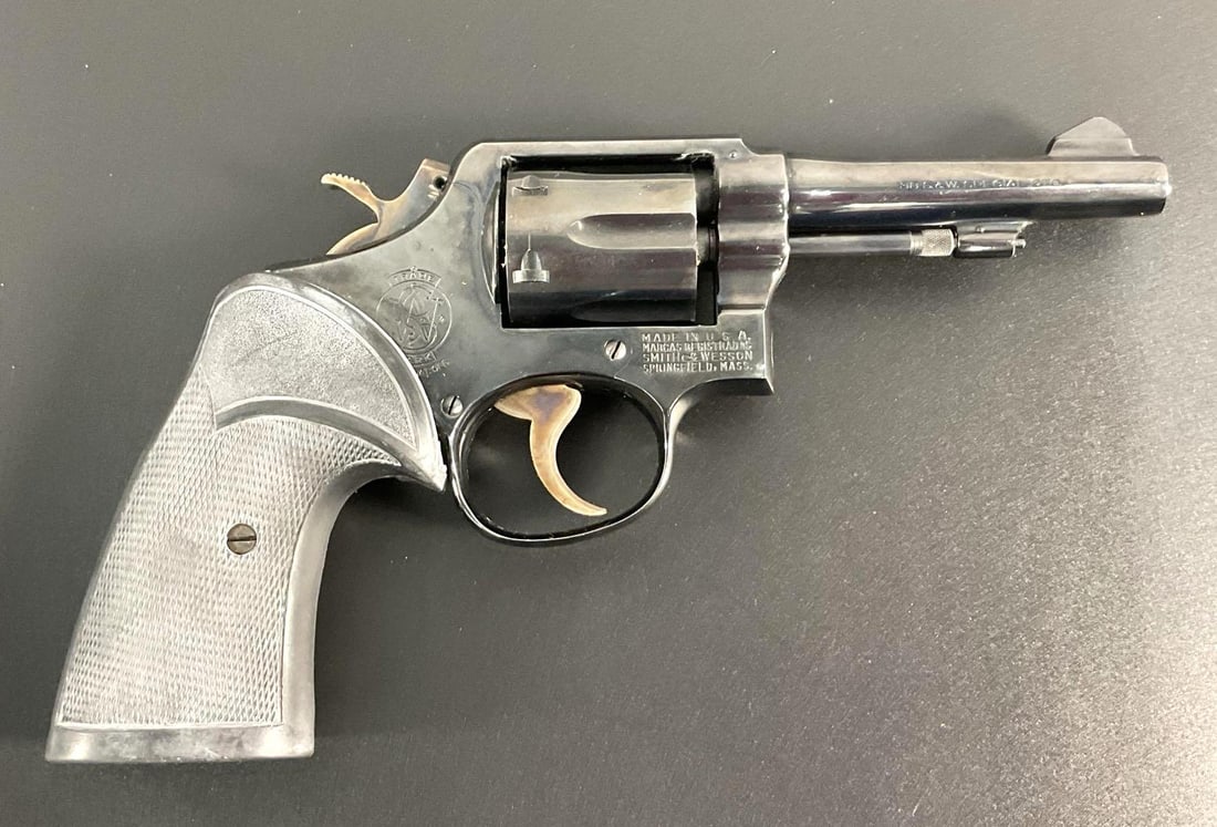 Colt Official Police Revolver: The firearm shown is a Colt Official Police revolver, chambered in .38 Special. This was a widely used law enforcement and military revolver throughout much of the 20th century, known for its durabili