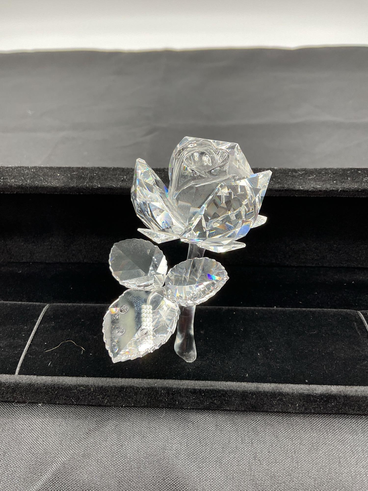 Vintage Swarovski Crystal Rose Figurine, Marked: Sparkling clear crystal rose figurine with intricately faceted petals, leaves, and stem. The leaves are adorned with small crystal accents, enhancing the light refraction and decorative appeal. Dimens