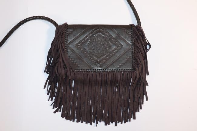 BCBG Generation Fringe Purse: A stylish leather purse from BCBG Generation featuring a fringe design on the front flap. The bag is compact, designed for casual or semi-formal use, and comes with an adjustable crossbody strap for c