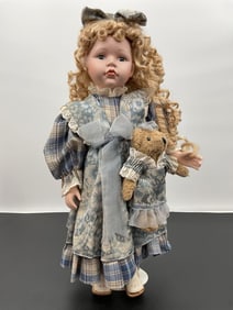 Title: Porcelain Doll with Blue Plaid Dress and Teddy Bear
