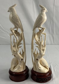 Pair of carved bird sculptures on wood bases