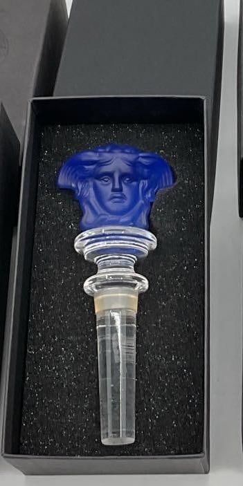 Rosenthal Versace Medusa Crystal Bottle Stopper - Blue: Rosenthal Versace Medusa Crystal Bottle Stopper with an iconic symbol of the brand. Housed in original black foam-lined box, this collectible stopper is a luxurious bar accessory. Dimensions: length 5