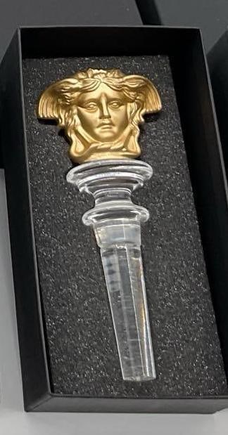 Rosenthal Versace Medusa Crystal Bottle Stopper - Gold: Rosenthal Versace Medusa Crystal Bottle Stopper with an iconic symbol of the brand. Housed in original black foam-lined box, this collectible stopper is a luxurious bar accessory. Dimensions: length 5