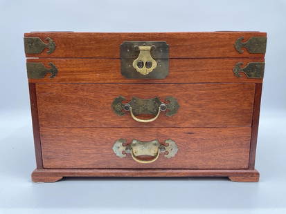 Vintage Wooden Flatware Box with Noritake Stainless Utensils: A finely crafted wooden flatware chest featuring brass accents and a circular Chinese longevity symbol on the lid. The interior is lined in blue velvet and houses a collection of ornate Noritake flatw