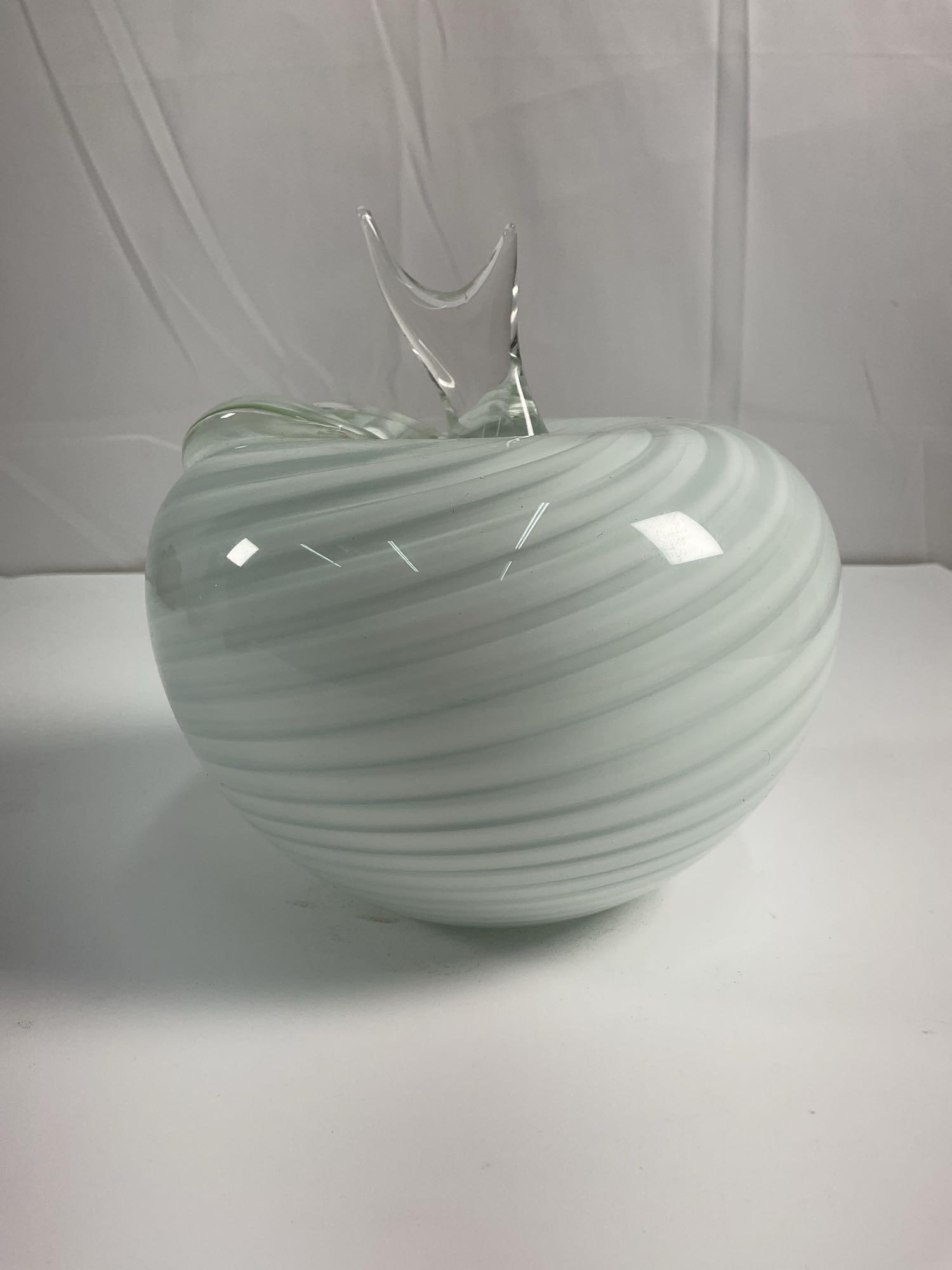 Vintage Murano Apple Glass Sculpture: A beautifully crafted glass with a swirled design in soft white. The piece features a clear glass accent shaped like a leaf or abstract flourish, adding an artistic and functional element. The harmoni