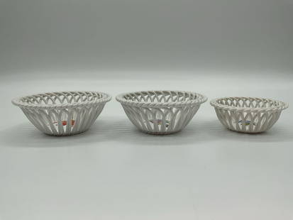 Herend Hungary Handpainted Porcelain Basket Trio: This set includes three intricately woven porcelain baskets from Herend, Hungary, each featuring delicate handpainted floral motifs at the center. The baskets are crafted in an open lattice design