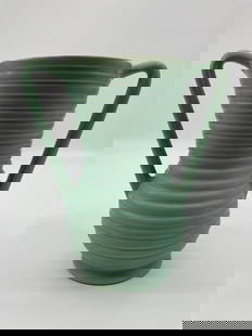 Art Deco Ribbed Pottery Vase with Double Handles: Tall ceramic vase featuring a flared rim and deeply ribbed body, finished in a matte celadon green glaze. Accented by sharply angled double handles, this piece reflects classic Art Deco styling, likel