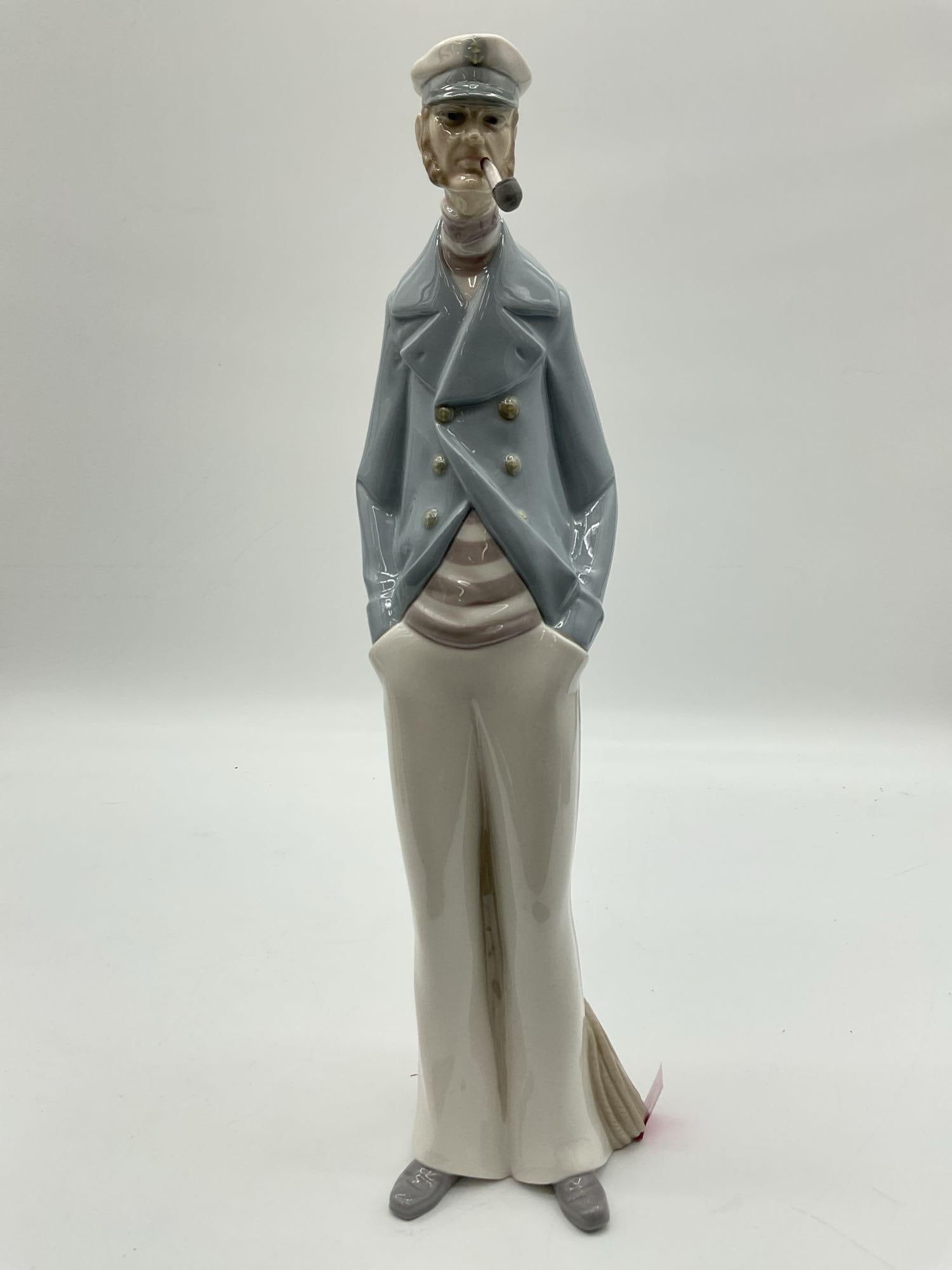 Retired - "Sea Captain " Porcelain figurine - 4621: Tall figurine of a sailor with hands in pockets, wearing a cap and smoking a pipe. Finished in glazed porcelain with soft blue and white tones. Medium: glazed porcelain
