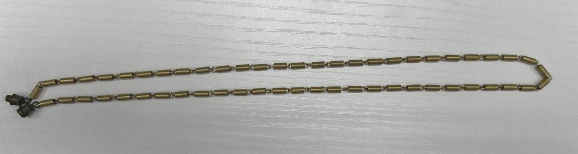 Vintage Industrial-Style Necklace with Coil Links: A unique vintage necklace composed of cylindrical gold-tone spring coil links, joined by small metal rings. The piece features a screw-barrel clasp typical of mid-20th-century costume jewelry.