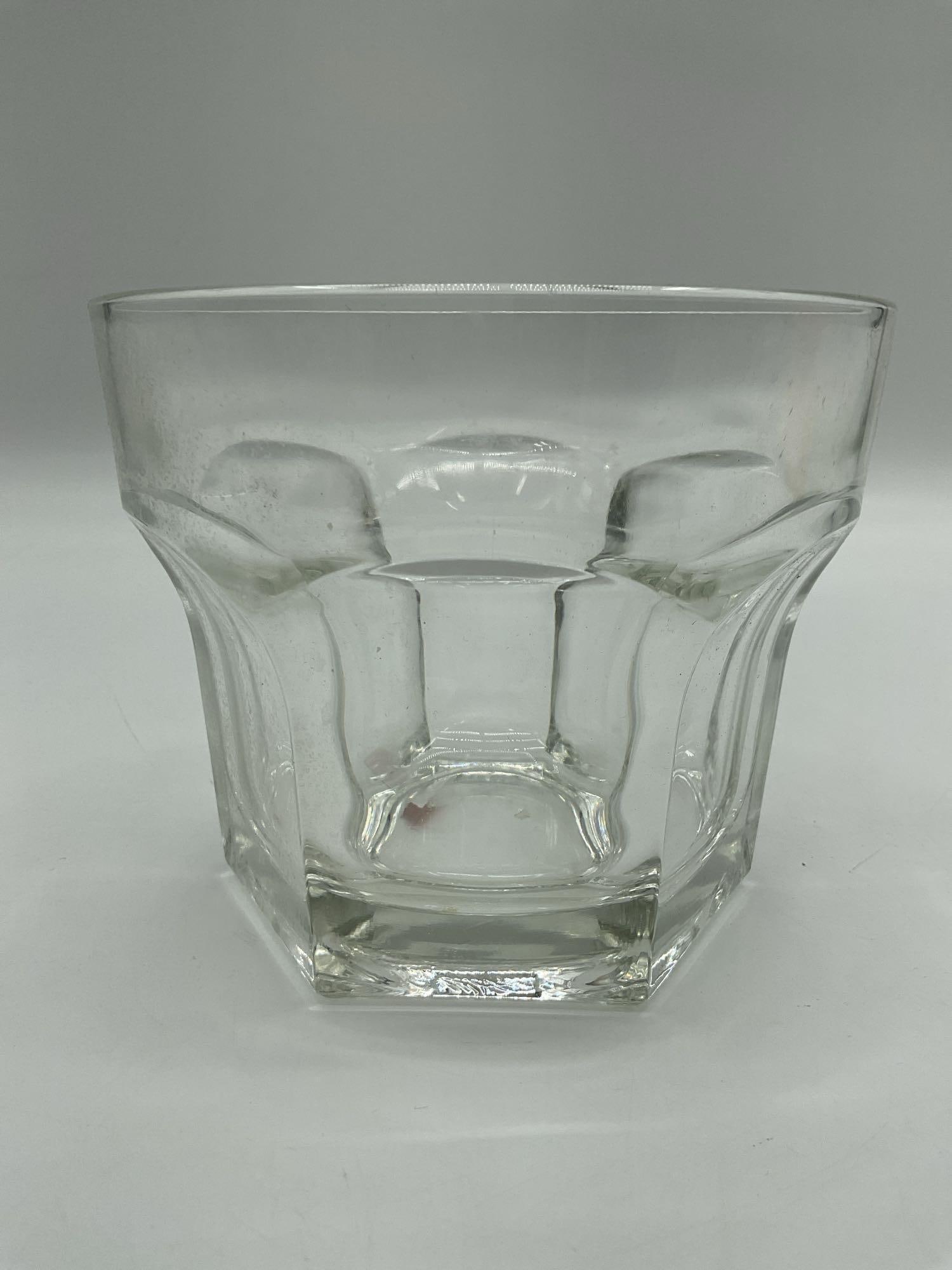 Heavy Clear Glass Faceted Whiskey Tumbler: Solid clear glass tumbler with a thick base and faceted sides, ideal for serving whiskey or spirits. Dimensions: H5in Dia6in Medium: Pressed glass