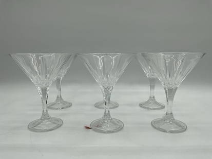 Set of 6 Clear Cut-Style Martini Glasses: Elegant set of six martini glasses featuring faceted bowls and smooth stems, designed to reflect light in a classic cocktail presentation. Dimensions: H7in Dia5in each Medium: Pressed glass