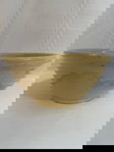 Yellowware Bowl - Box 14: This classic yellowware mixing bowl features a smooth, glossy glaze with subtle decorative banding near the rim. Yellowware was widely produced in the 19th and early 20th centuries and is highly colle