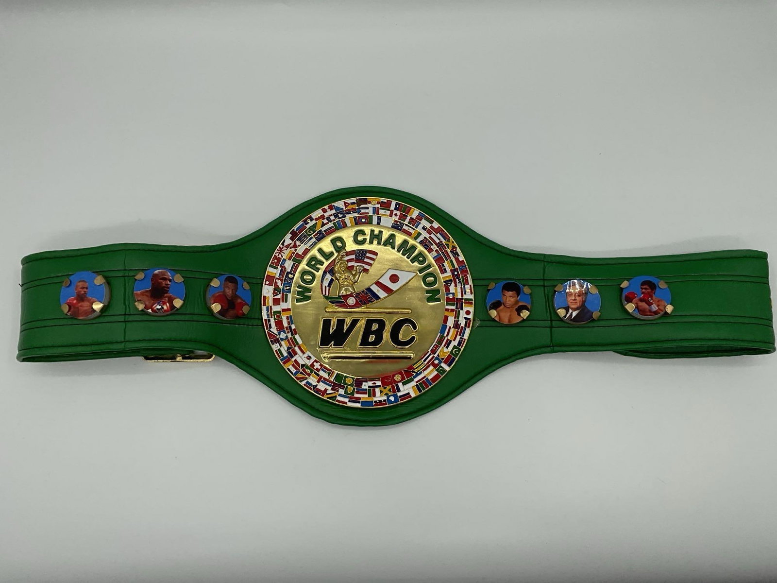 WBC World Champion Boxing Belt Replica: This is a replica of the iconic green World Boxing Council WBC championship belt, featuring a central gold medallion with the WORLD CHAMPION and WBC logos surrounded by international flags. The sides 