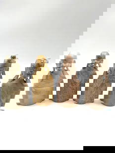 Set of 4 African Tribal Bust Sculptures: Group of four hand-carved stone busts representing East African tribal figures, each featuring elongated earlobes and traditional hairstyles or adornments. Each bust is carved from a different type of