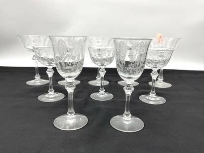 Set of 10 Etched Crystal Stemware Glasses: Description: Vintage etched crystal stemware featuring an ornate floral and medallion pattern, including both coupe and goblet-style glasses with faceted stems. Dimensions: H: 6in Dia: 4in, H: 6in