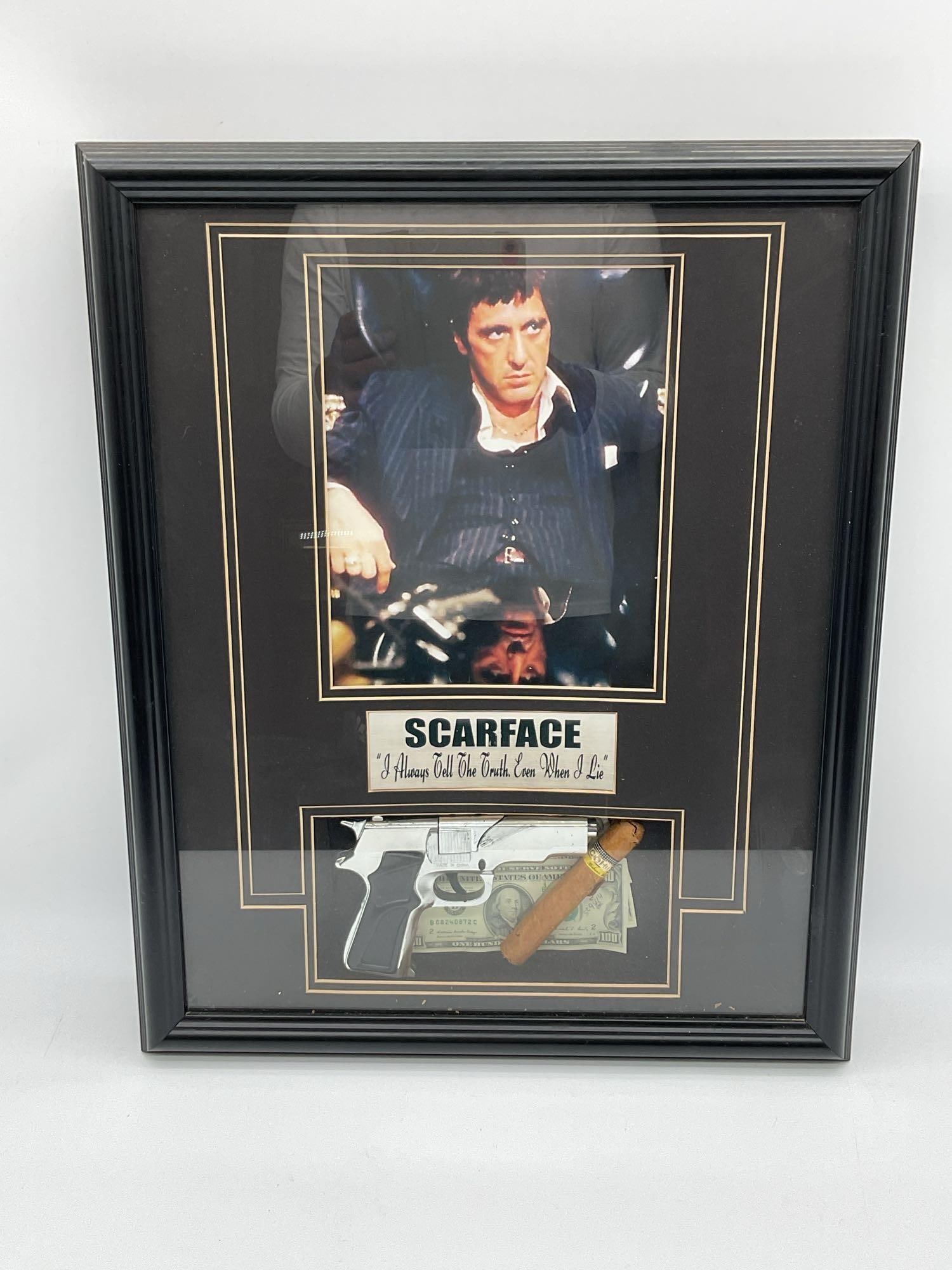 Scarface Movie Display with Cigar and Replica Gun: Framed Scarface memorabilia featuring a classic image of Tony Montana from the 1983 film, with a quote below reading I always tell the truth. Even when I lie. The lower section includes a replica silv