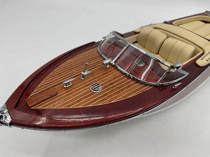 Riva Aquarama Model Speedboat: Detailed scale model of the iconic Riva Aquarama wooden speedboat with chrome detailing, cream leather-style seats, and rich mahogany deck Dimensions: H20in L7in W4in Medium: Wood and metal model boat