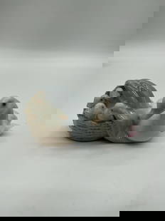 Lladro Mother Duck with Ducklings Figurine: A glazed porcelain sculpture of a nesting duck beside four ducklings in a cozy nest, rendered in soft pastel tones. Dimensions: H2in L4in W4in Medium: Glazed porcelain