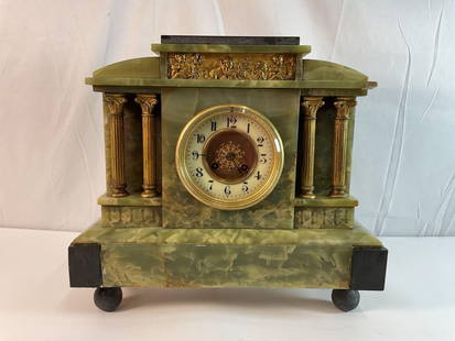Onyx and Dore Bronze Mantel Clock: This is a stunning antique mantel clock, featuring a green onyx and gilded bronze or brass case in a neoclassical architectural style. The clock's design includes four bronze columns with Corinthian-s