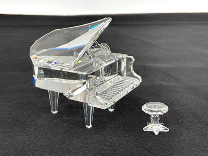 Swarovski Crystal Grand Piano with Stool: Clear faceted crystal miniature grand piano with separate matching crystal stool. Highly detailed and reflective, showcasing Swarovski’s signature craftsmanship. Dimensions: piano H3in L3in W3in, st