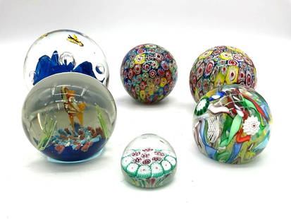 Blue Flower and Millefiori Art Glass Paperweights: Group of vibrant art glass paperweights including a blue flower encased in clear glass with bubbles and fish, and a colorful millefiori design with embedded shapes. Dimensions: Diameter 2-4in Medium: