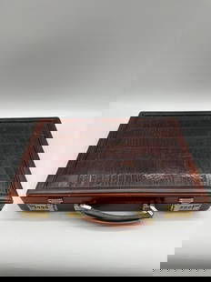 Vintage Crocodile Embossed Leather Briefcase with Gold Combination Locks: A stylish vintage briefcase featuring a patchwork crocodile-embossed leather front panel, secured with dual gold-tone combination locks. The piece has a sturdy top handle and classic brown leather tri