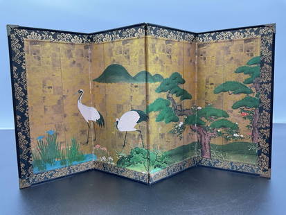 "Japanese Crane and Pine - Byobu Folding Screen: This exquisite folding screen painting features elegant Japanese cranes standing near a pond surrounded by lush greenery and a gnarled pine tree. The background is adorned with a stunning gold-leaf gr