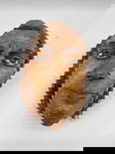 Hand-Carved Coconut Shell Face Mask: Uniquely crafted face mask made from a coconut shell, featuring hand-carved facial features and painted details with inset eyes. The natural coconut fibers on the back are styled to resemble hair, add
