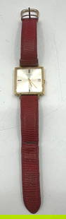 Juvenia Swiss Square Dress Watch with Date Display: Vintage men&#39;s square-face wristwatch by Juvenia, featuring a brushed silver-tone dial, gold-tone hands and indices, and a date display window at 3 o&#39;clock. Encased in a gold-tone metal frame w