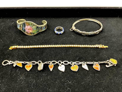 Mixed Vintage Costume Jewelry Lot with Bracelets Charms and Ring: Assorted vintage costume jewelry including a charm bracelet with heart and leaf motifs, a gold-tone bracelet, a floral inlay cuff bracelet, a thick orange bangle, and a silver-tone band ring. Various