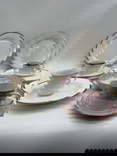 Assorted Mismatched Fine China Cups, Saucers, and Plates: Description: Group of vintage porcelain teacups, saucers, and dinner plates in coordinating but mismatched patterns. Includes floral motifs, gilt accents, and classic Greek key border designs. Glazed
