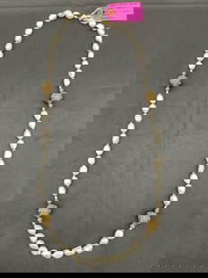 Freshwater Pearl and Bronze Bead Necklace: Elegant necklace featuring irregular freshwater pearls paired with ornate bronze accent beads in large and small sizes. Dimensions: length 42in Medium: Freshwater pearls, bronze