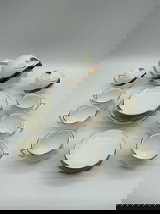 Jiesia Fine Bone China Tea Set, Lithuania: Description: Elegant white fine bone china tea service set by Jiesia, Lithuania. Includes teapot, sugar bowl, creamer, cups, and saucers, all trimmed with fine gold edging. Known for its minimalist fo