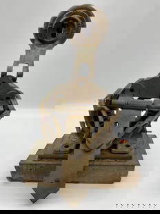 Abstract Sculpture with Industrial Parts and Bearings: This abstract assemblage sculpture is crafted from solid industrial materials, including a piston rod, hinge, gears, and metal plates, all mounted on a rectangular base. The composition features a str