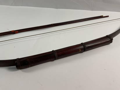Traditional Wooden Recurve Bow with Arrows: This is a traditional wooden recurve bow, featuring a curved limb design that allows for greater draw strength and accuracy. The bow appears to be handcrafted with a wrapped grip and a taut bowstring,